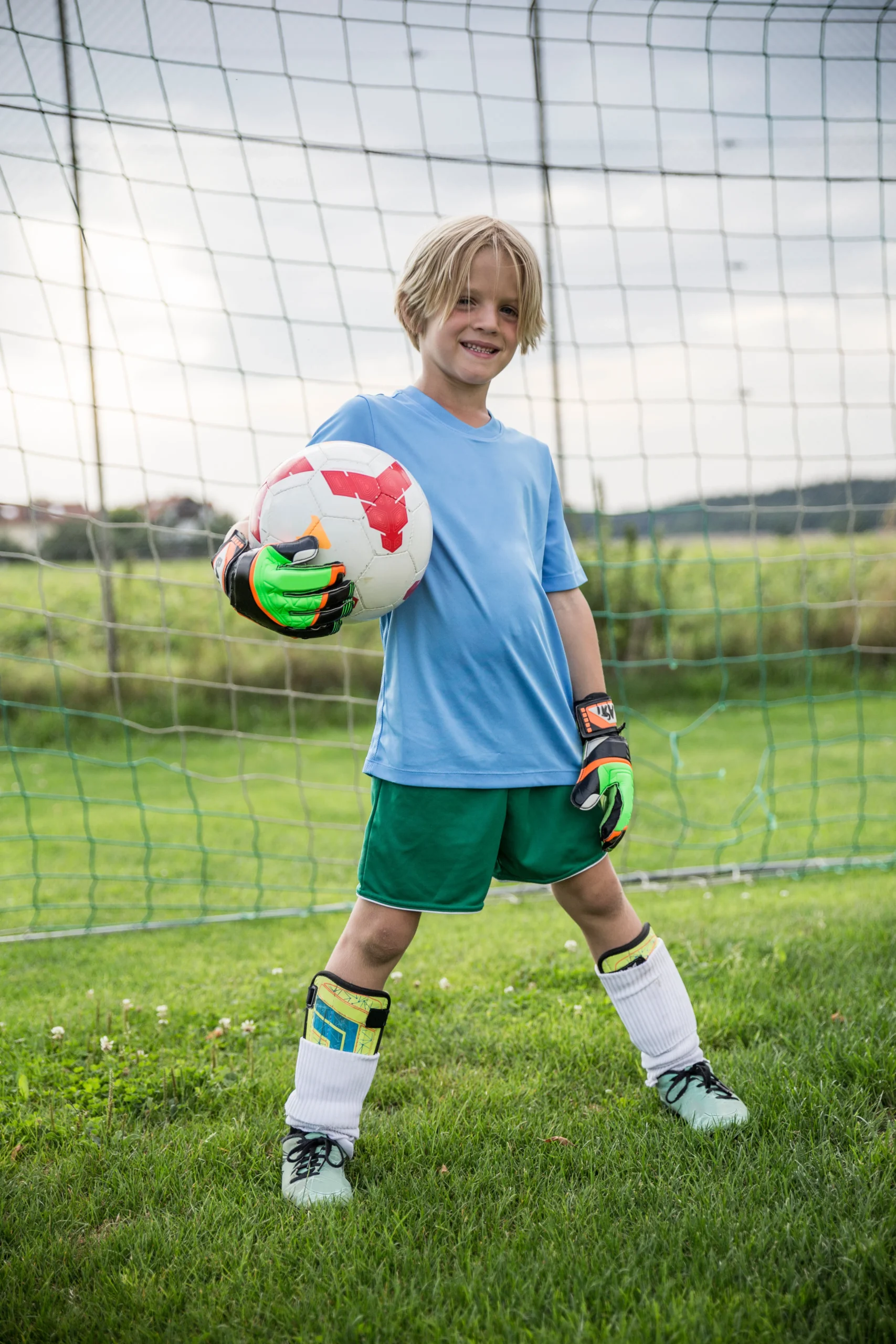 portrait-of-smiling-young-footba